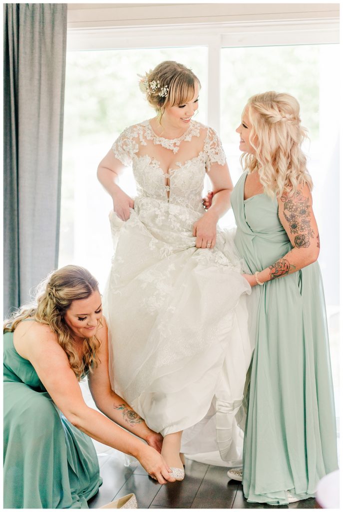 Bride getting her shoes on, Whimsical wooded wedding