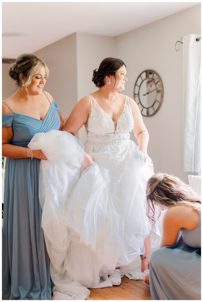 bride and bridesmaids getting dressed 